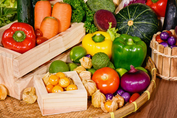 Arrangement various fresh fruits and vegetables in wooden container