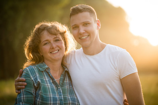Portrait of mother and son, outdoors. Nature background.