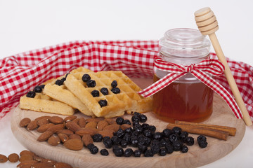 Honey in jar on a wooden background