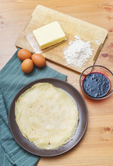 Top view of the ingredients for making traditional thin pancakes.