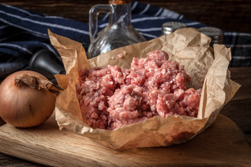 Minced meat on wooden background.