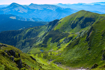 Naklejka na ściany i meble Amazing mountain gorge among the green alpine meadows