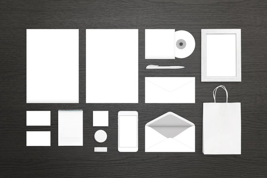 Clean white stationery for identity design presentation. Top view of black desk.