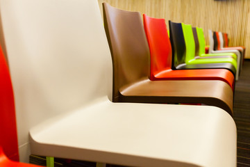 Colorful chairs arranged in a meeting room.