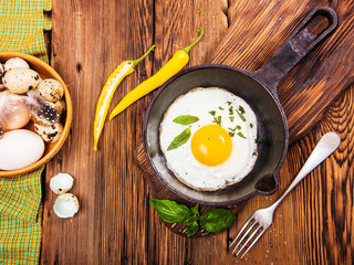 Rural breakfast with eggs and spices on a wooden background