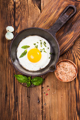 Rural breakfast with eggs and spices on a wooden background