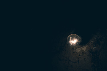 Electric lamp on a background of a clay wall