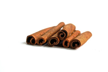 Closeup of cinnamon sticks on a white background