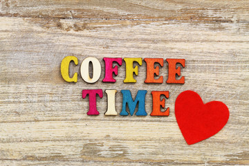 Coffee time written with colorful wooden letters and red heart
