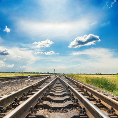 Fototapeta premium railroad crossing closeup under blue cloudy sky