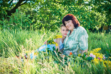 Grandmother and granddaughter with flowers