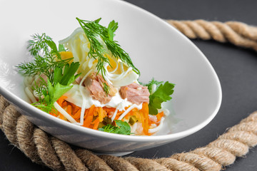 Plate with tuna salad with eggs, carrot, onion and mayonnaise
