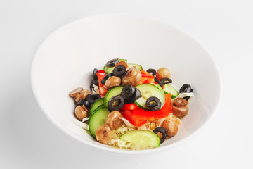 Plate with salad with mushroom, olives, cucumber and pepper on white background