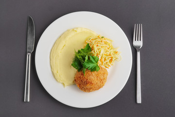 Top view of chicken Kiev cutlet with mashed potato