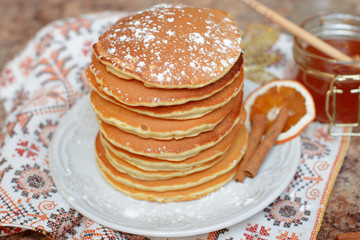 Well baked pancakes are topped with honey for an extra taste. 