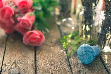 The branches in a glass jar on the background of flower on the wooden