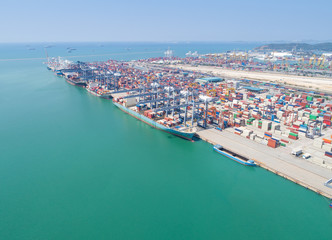 Fototapeta premium Ship for container with working crane bridge in shipyard for Logistic Import Export background