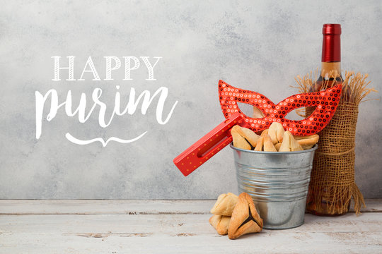 Jewish holiday Purim greeting card with hamantaschen cookies or hamans ears, carnival mask and wine bottle