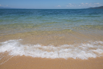 wave of blue sea on sandy beach. Background.