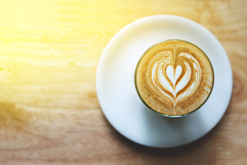 heart drawing on latte art coffee on wood table background