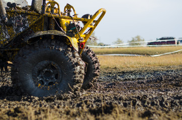 Off-road car in a puddle making mud splashes.