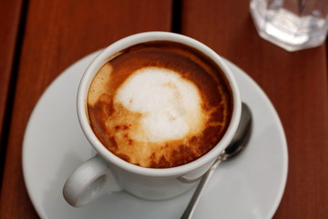 Coffee cup on wooden background