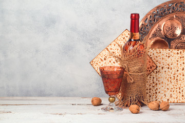 Passover holiday concept with wine and matzoh over rustic background with copy space