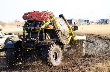 Off-road car in a puddle making mud splashes.