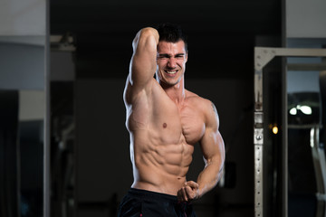 Naklejka na ściany i meble Serious Bodybuilder Standing In The Gym