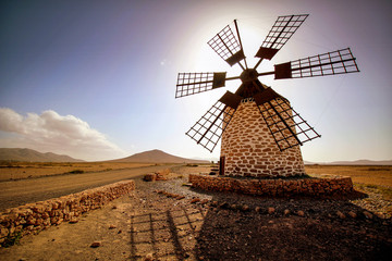 windmill in front of the sun at fuenrteventura
