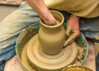 Fototapeta na wymiar potter makes earthen vessel