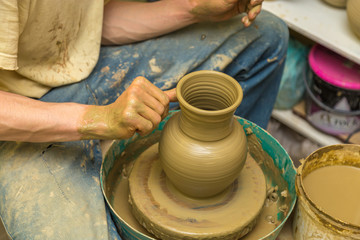 potter makes earthen vessel