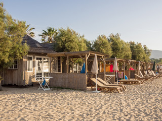 Beach huts in early morning sunshine before sun worshippers appear, Port-grimaud, France