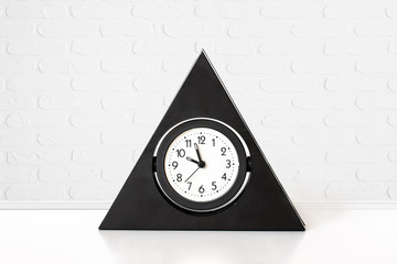 Alarm clock against white bricks wall  background