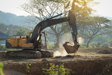 Excavator digging and removing earth ..Digger machine adjusting ground level in construction site..