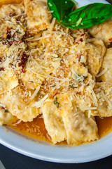 Ravioli with bacon cheese and white sauce.