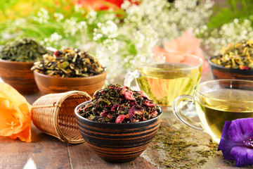 Composition with cup of tea and bowls of tea leaves