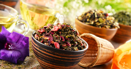 Composition with cup of tea and bowls of tea leaves