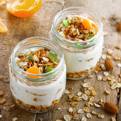 Yogurt, granola and fruits in a jars for delicious breakfast. Traditional American healthy food. Top view shot.