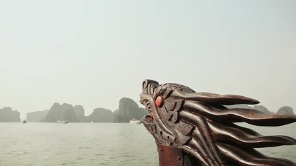 A boat with a dragon's head floating in the ocean. Vietnam. Ha Long Bay.