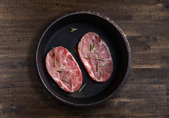 steak with rosemary and pepper , top view