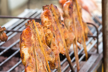 half fried chicken on sticks
