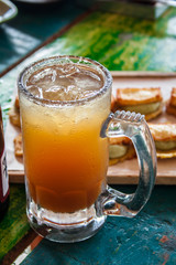 Natural Michelada with lemon and beer in a frozen glass jar. - 138491184