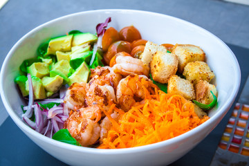 Shrimp salad with abocado in a white bowl