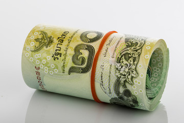 Close up Thai Baht roll tightened with band isolated on white background.