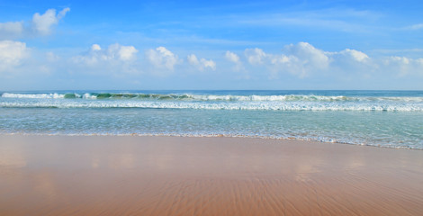 ocean, sandy beach and blue sky