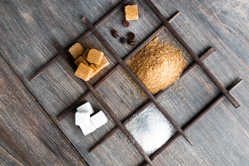 Variety of sugar - cane brown and white sugar in powder and cubes.