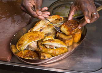 Roasted chicken with foie gras being served in a metal pan.