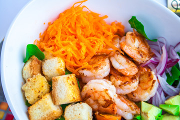 Shrimp salad with abocado in a white bowl