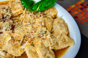 raviolis with onion and white sauce and cheese